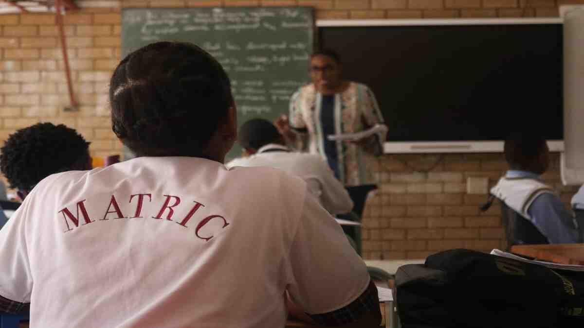 A matric learner sitting in a classroom.
