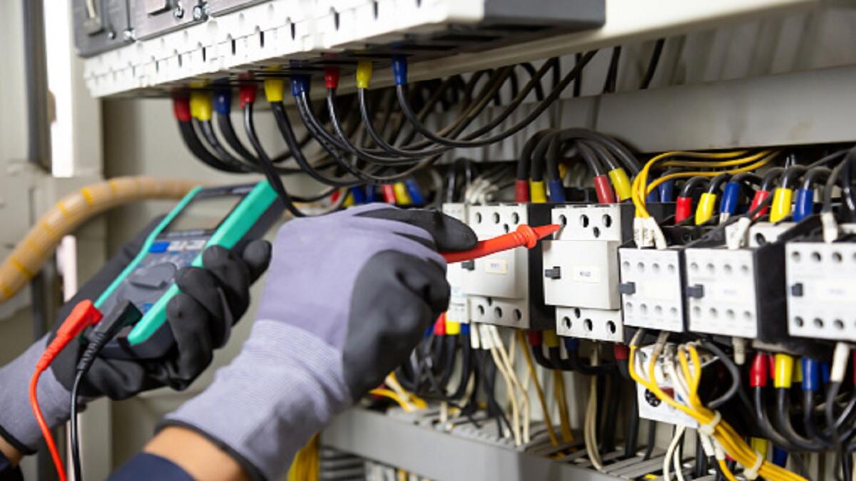 An electrical engineer working with a circuit and some wires. 