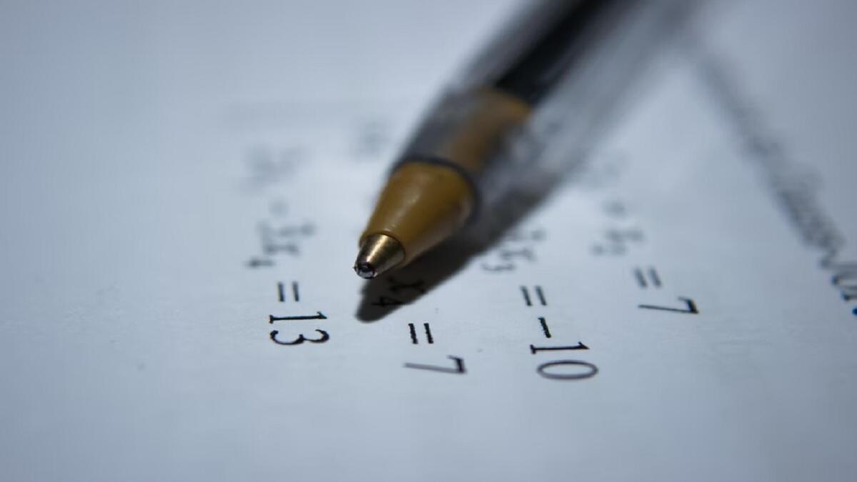 A pen on an IEB Matric Supplementary Examination Maths paper 